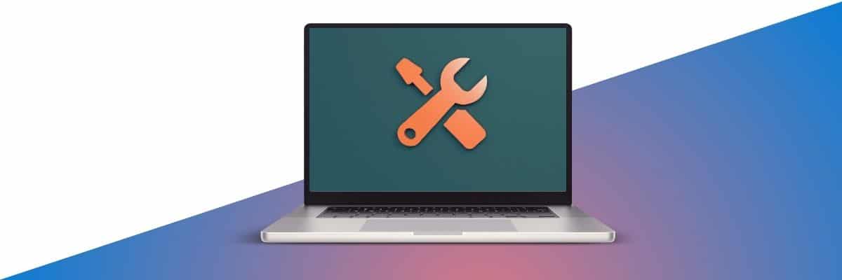 a laptop with a wrench and screwdriver on the screen